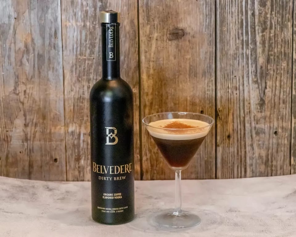 Belvedere Dirty Brew organic coffee flavored vodka bottle next to a martini glass with a coffee cocktail.
