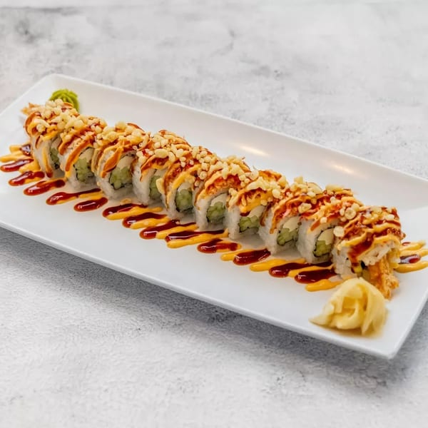 Sushi roll with crispy toppings and two sauces, served with ginger and wasabi.